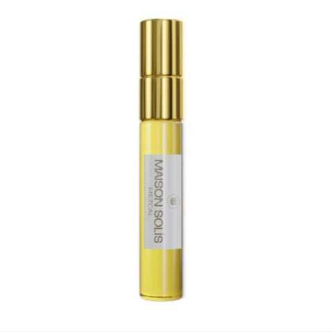 Yellow and gold cosmetic bottle with a white label on a white background